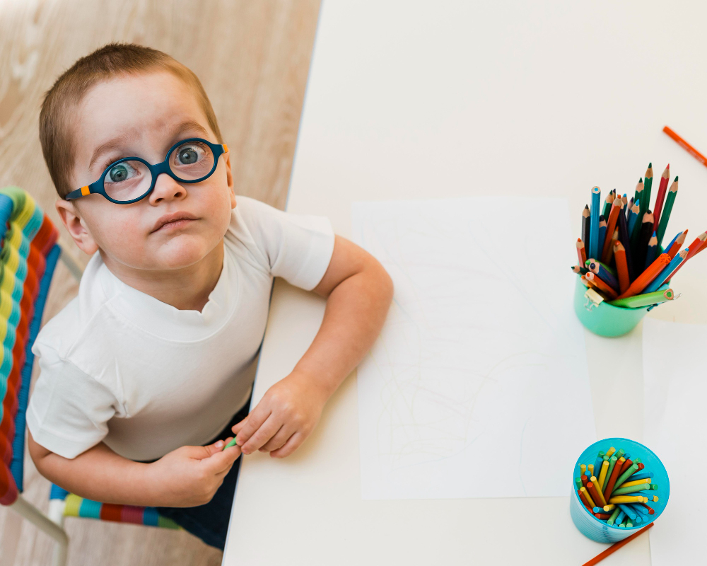 boy looks up from table