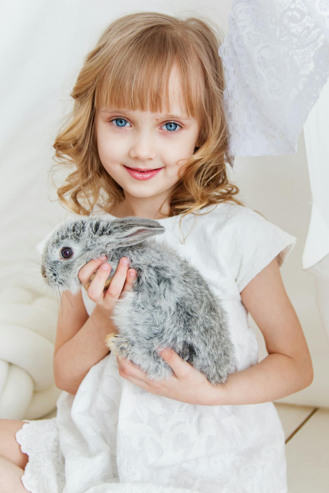 Girl smiling holding rabbit