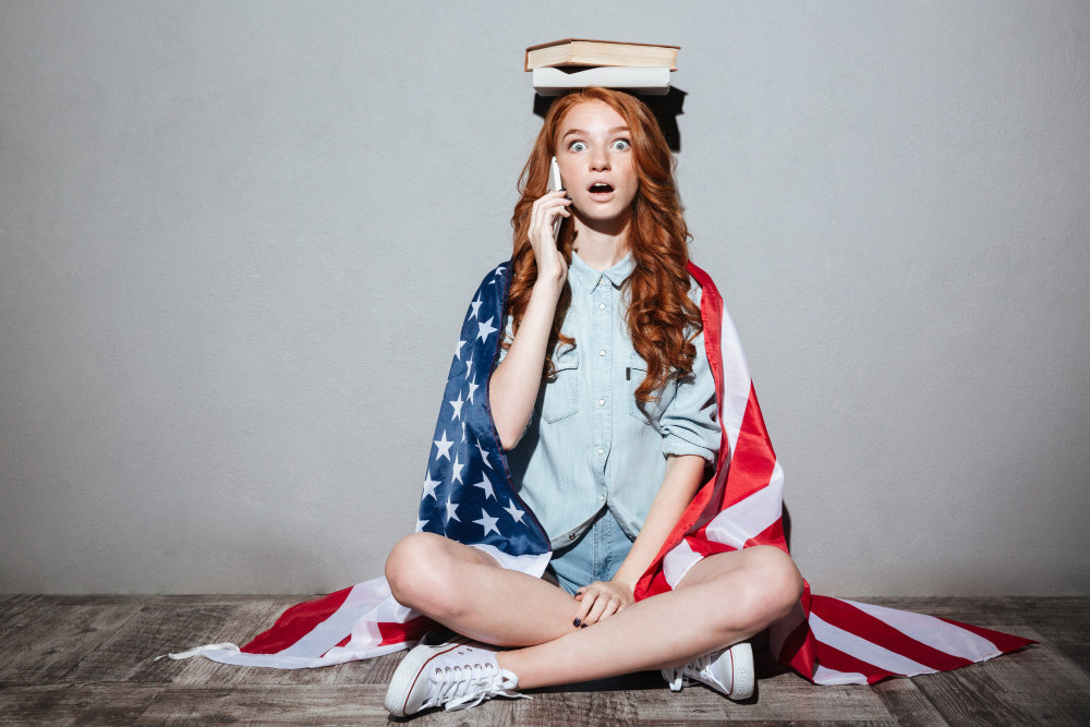 woman with US flag and book on head