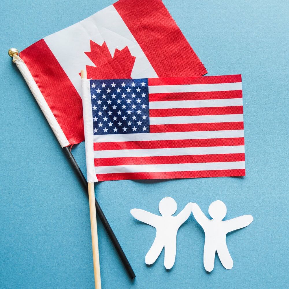 Canada and US flag and paper dolls